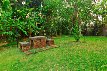 Rock or laterite of table set in floral garden