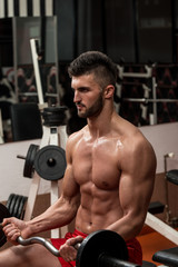 Fototapeta na wymiar Young Men Doing Exercise For Biceps