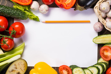 Vegetables tiled around a sheet of paper