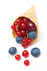 Assorted fresh seasonal berries in a waffle cone isolated