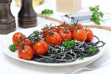 black pasta with baked tomatoes and parsley