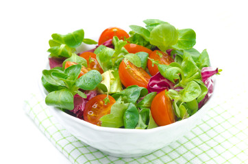 fresh salad and cherry tomatoes in a bowl, isolated