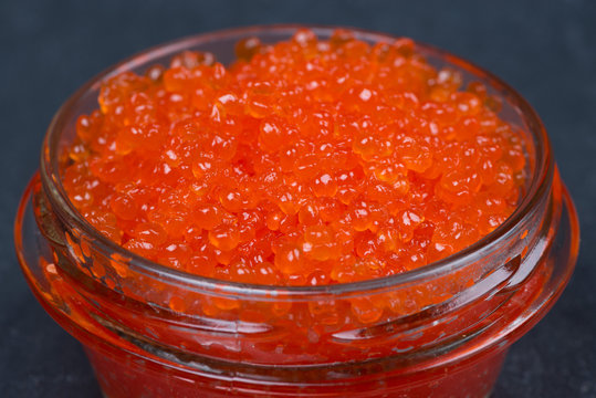 glass jar of red caviar, close-up, selective focus