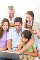 Fototapeta premium Multigeneration family using laptop