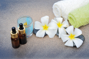 Obraz na płótnie Canvas white frangipani with zen stones essential oil and towel