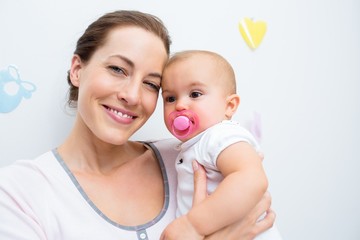 Closeup of mother and baby with pacifier