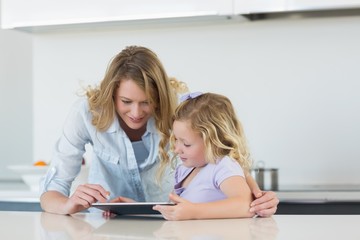 Fototapeta na wymiar Mother and daughter using tablet computer