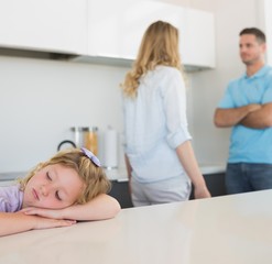 Fototapeta premium Girl leaning on table while parents arguing
