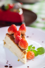 Cheese cake and ice-cream on plate with fruit topping.