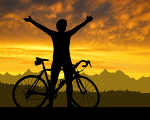 Obraz premium Silhouette of the cyclist on road bike at sunset