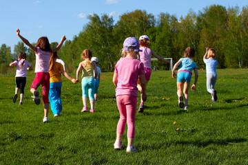 group of children running around the stadium