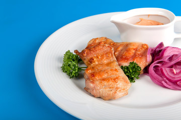 Grilled meat with vegetables on a blue background