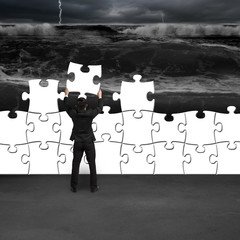 Businessman holding puzzles to assembly for changing situation