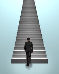 Businessman climbing on concrete stairs