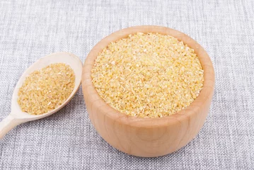 Fototapeten Wheat cereal in a bowl on the table. © dibas99