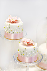 Wedding cakes in cream and pink with pearls.