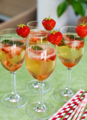 Summer cocktail with champagne, peppermint and fresh strawberrie