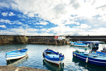 Naklejka na ściany i meble Fishing boat moored at the harbor of Acitrezza, Sicily