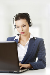 Beautiful young call-center assistant at the desk