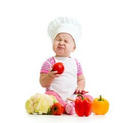 funny baby girl weared cook with vegetables