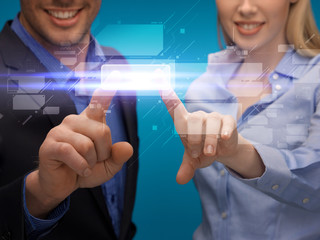 man and woman hands pointing at virtual screen