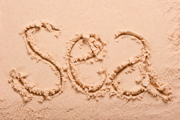 sea ​​inscription on the wet sand at the beach
