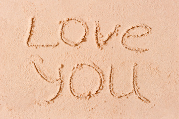 I love you written on wet sand on the beach