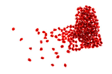 Red broken heart made of pomegranate seeds on white background