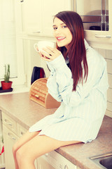 A young woman having morning coffee