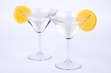 two glasses of martini and lemon on blue