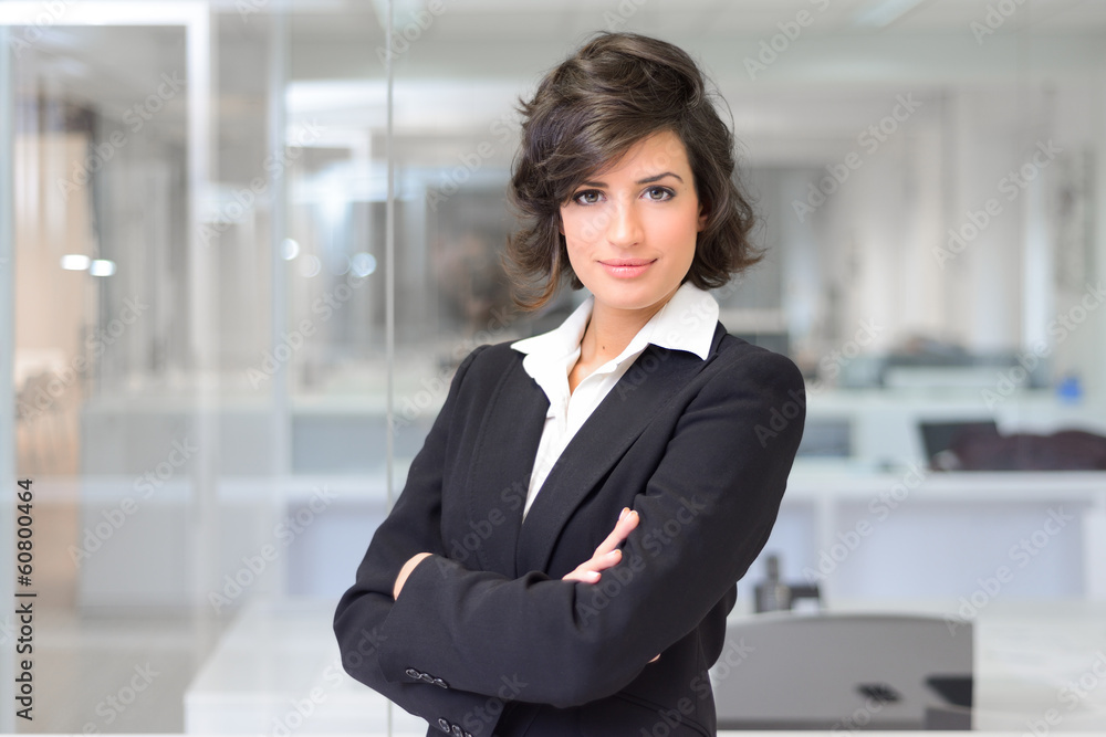 Wall mural business woman in an office. crossed arms