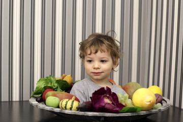 Fototapeta premium Boy and plate of fruits