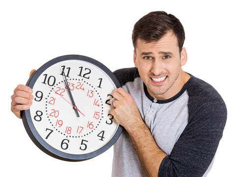 Man holding clock, stressed, running out of time