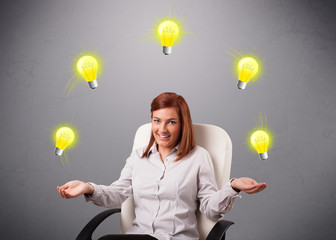 young lady sitting and juggling with light bulbs