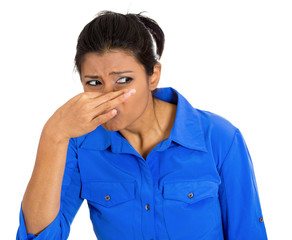 Woman covering nose, can't tolerate bad smell