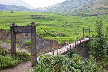Fototapeta na wymiar An old wooden foot bridge near Sapa in Vietnam