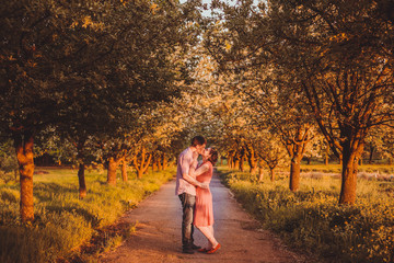 Portrait of young couple in flowering park