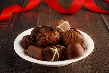 Chocolate pralines on vintage wooden table