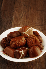 Chocolate pralines on vintage wooden table