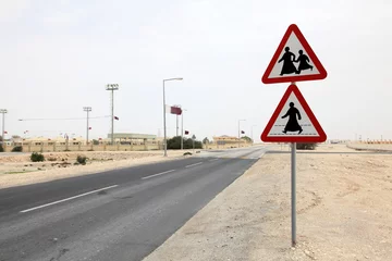 Photo sur Plexiglas moyen-Orient Arabian people crossing the road sign in Qatar, Middle East
