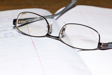 eyeglass on book