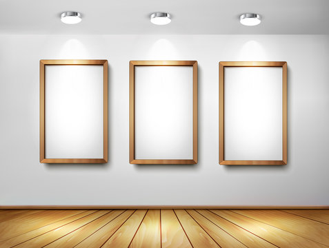 Empty wooden frames on wall with spotlights and wooden floor. Ve