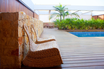 Teak wood house outdoor with swing chairs and pool