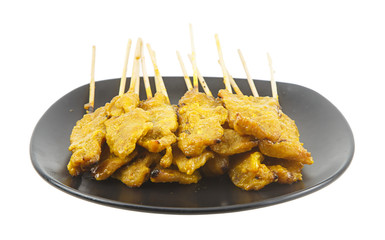 Pork satay on dish isolated on white