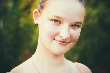 Portrait Of Face Young Beautiful Girl Woman On Green Outdoor Bac