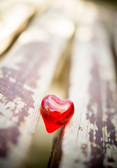 macro red heart on a vintage wooden chair