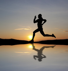 Fototapeta na wymiar Woman running at sunset