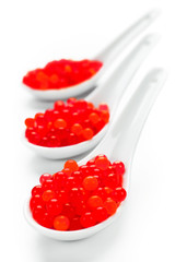 Red caviar on porcelain spoons uncluttered