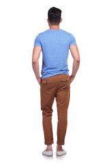 back view of a young casual man standing