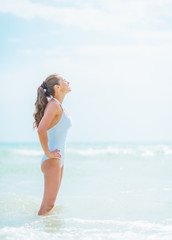 Fototapeta na wymiar Young woman in swimsuit enjoying sea